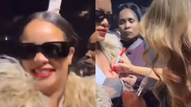 Rihanna ganha autógrafo de Mariah Carey no seio